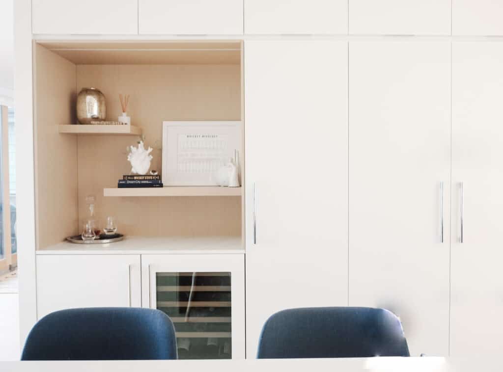 In the tour of signed Samantha's kitchen, the pantry is actually tall, long cupboards. Then there is a little bar area to the left with decorative shelvs and a wine fridge