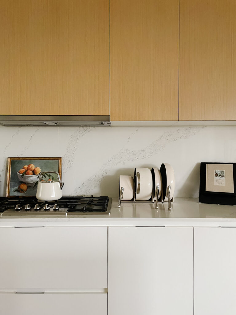 Caraway vs our place always pan with caraway pans sitting on the kitchen counter