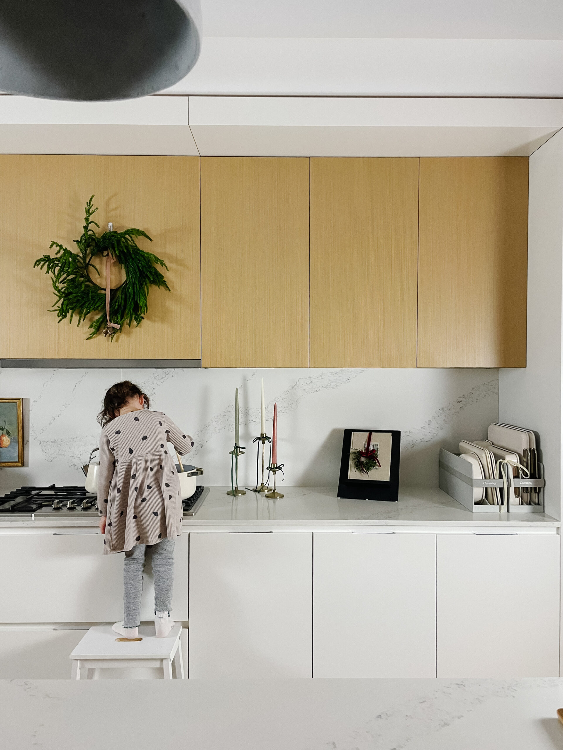 Little girl cooking in the kitchen with Caraway cookware