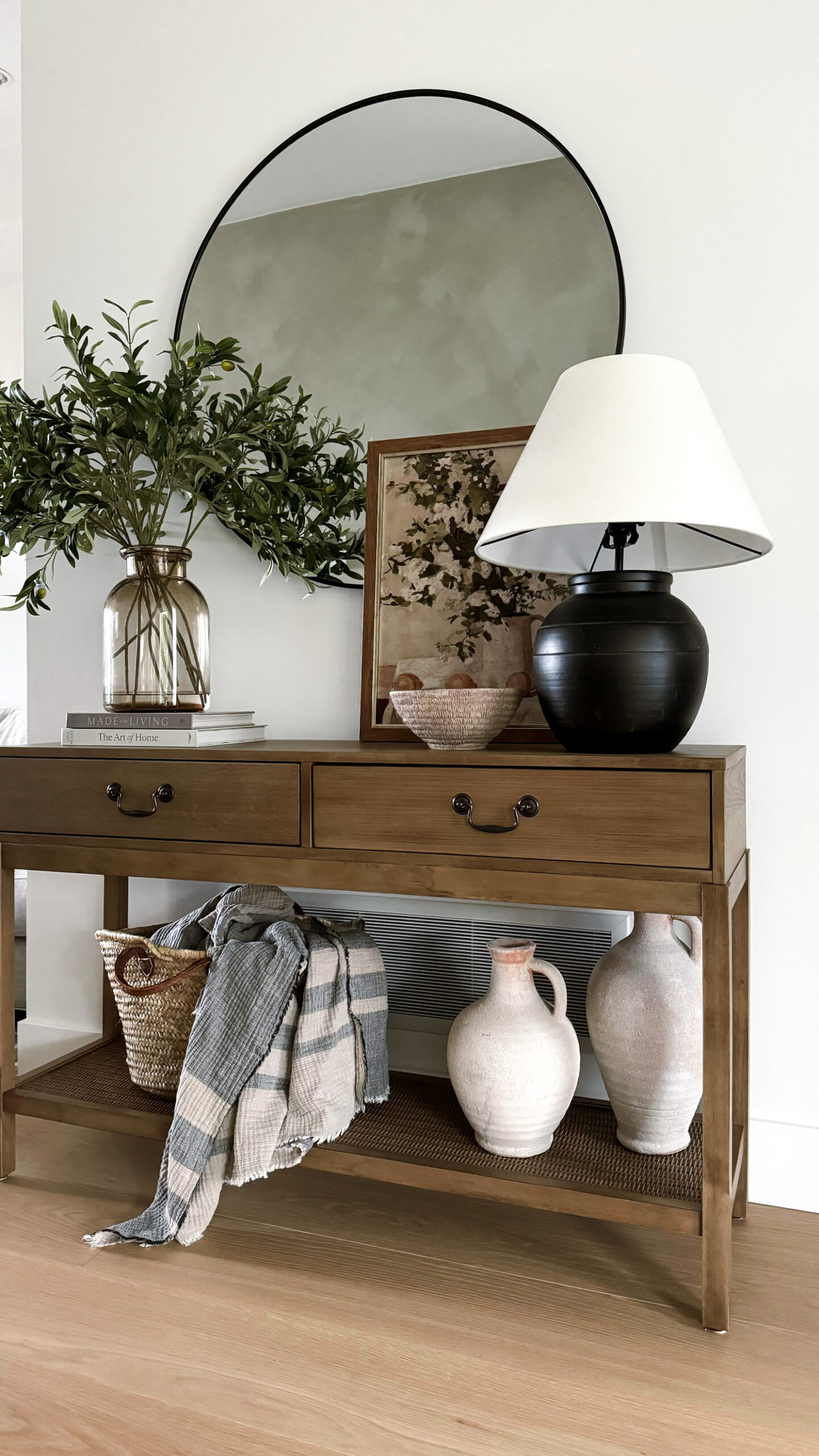 home decor on top of an entryway table including a spring art print.