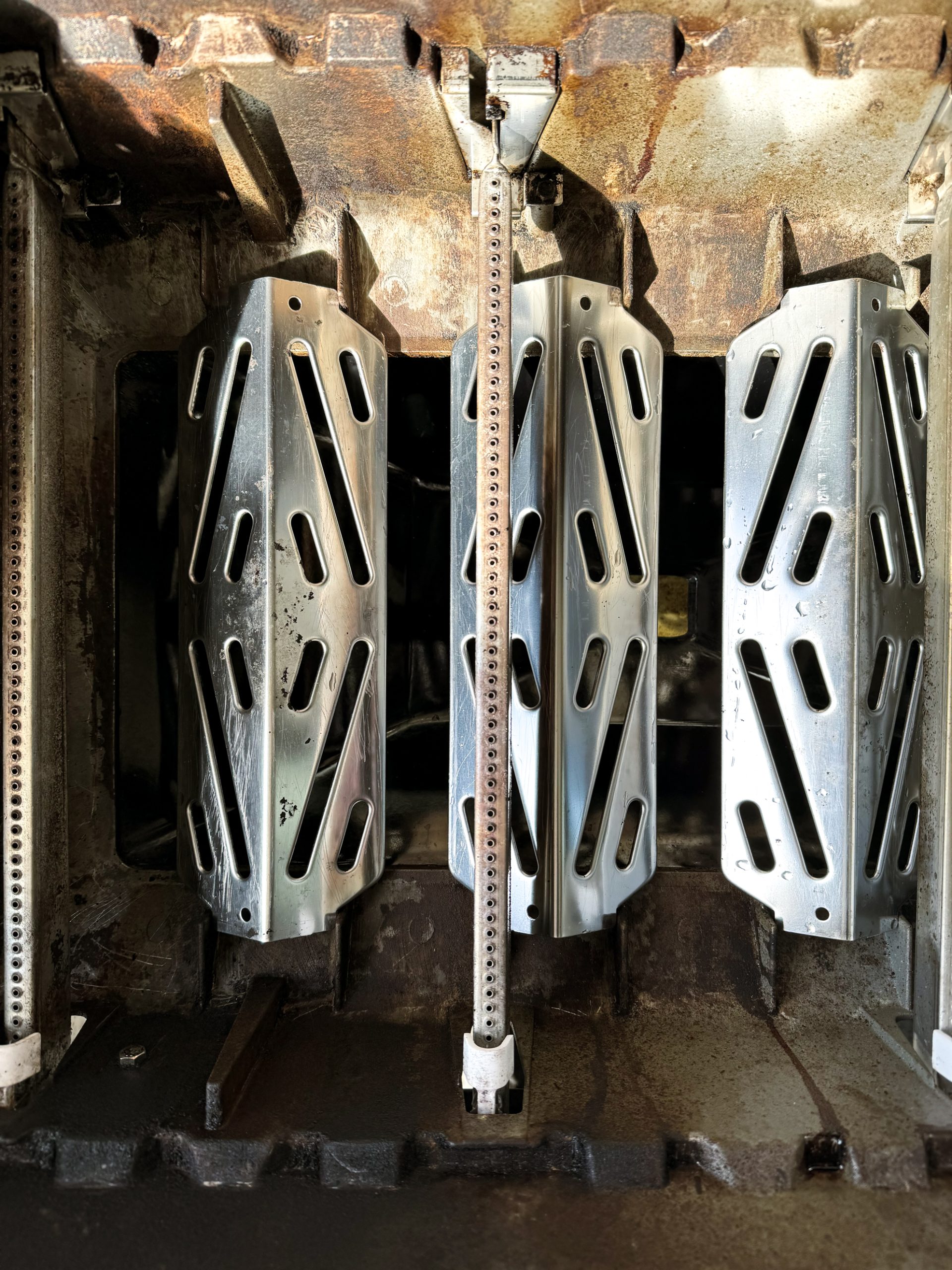 a clean inside of the bbq with heat shields back on