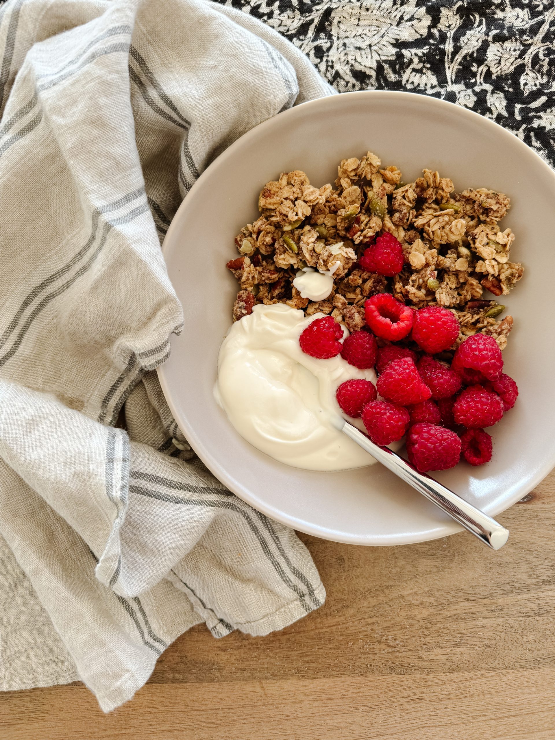 gluten-free granola in a bowl with raspberries and yogurt