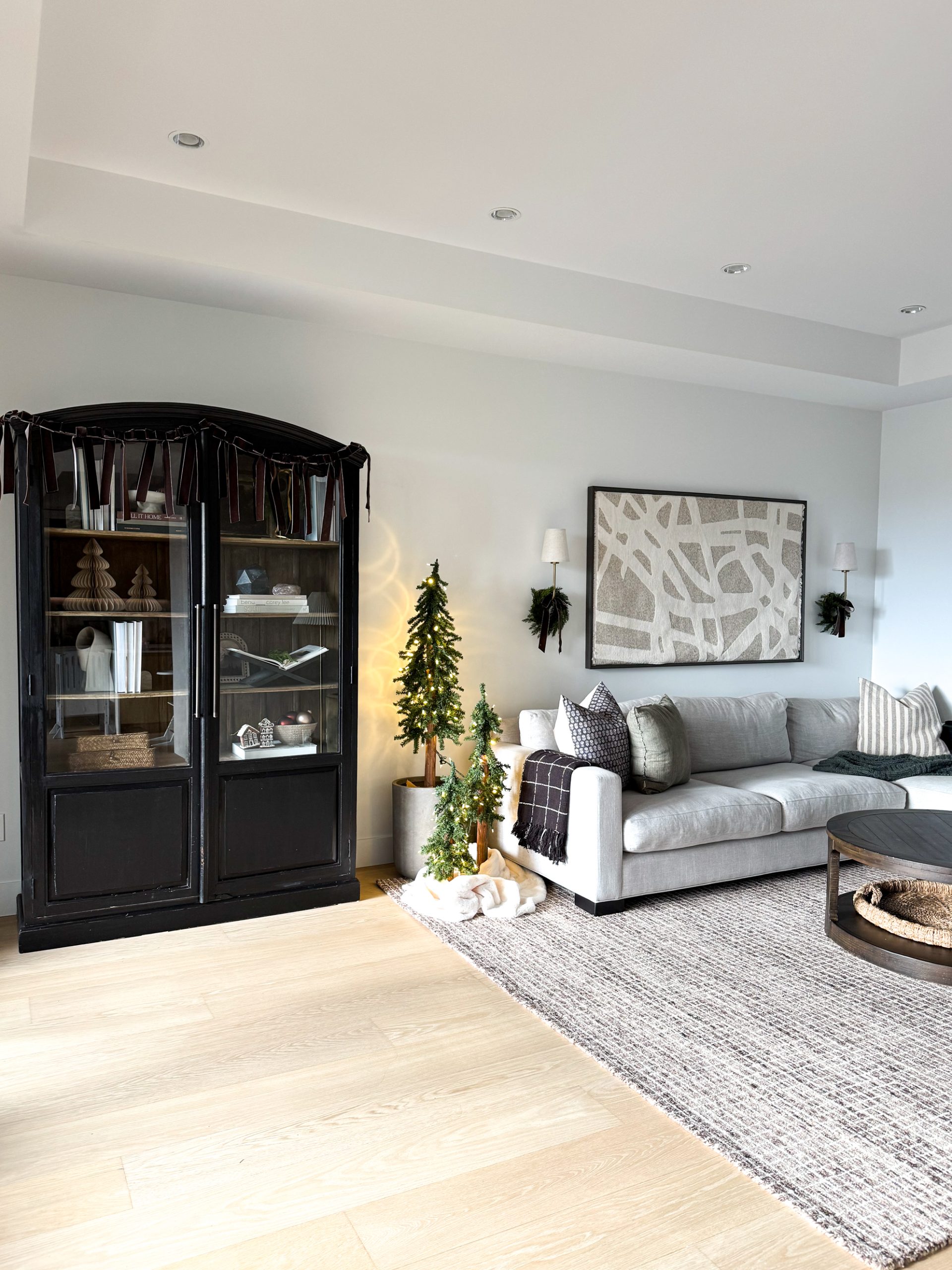 DIY bow garland on top of an arched cabinet in a living room