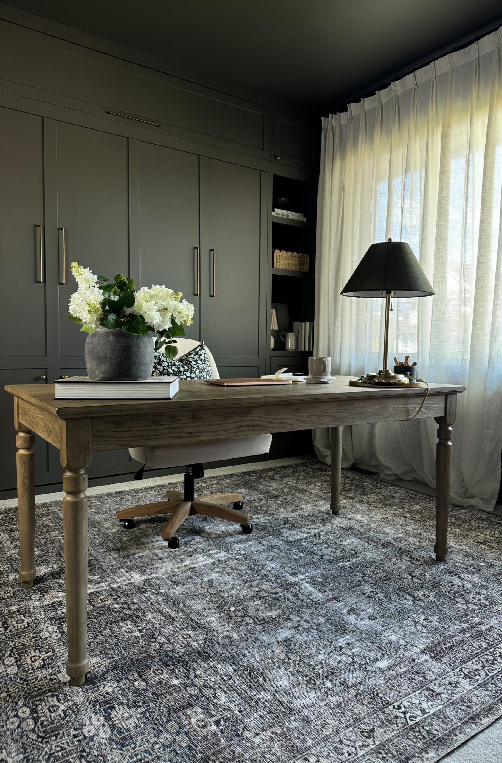 home office desk in the middle of a room. Hiding the cords