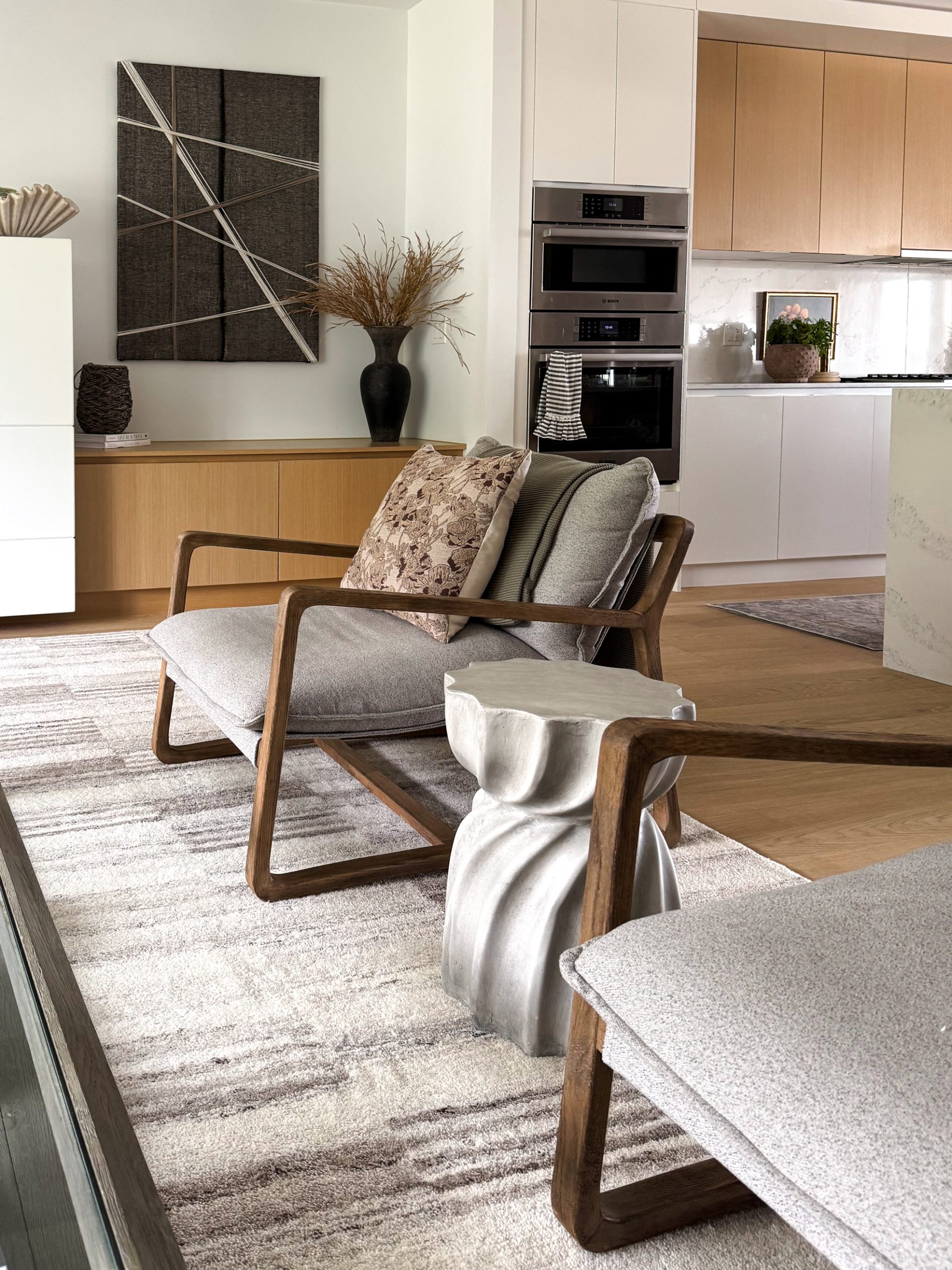 spring textures in a living room including a concrete wavy side table