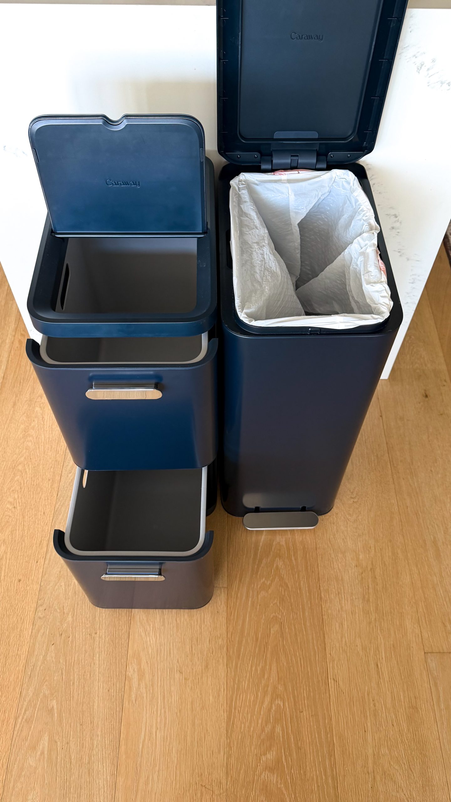 Caraway's new trash and recycling bins in Navy blue.